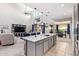 Bright, open floor plan with modern kitchen island, spacious living area, and dining space at 25546 N 164Th Dr, Surprise, AZ 85387
