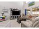 Bright living room with a soaring ceiling, large window, neutral colors, comfortable seating and built in entertainment center at 25546 N 164Th Dr, Surprise, AZ 85387