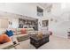 Open concept living room featuring vaulted ceilings, natural light, comfortable seating, stairs to the second floor, and kitchen at 25546 N 164Th Dr, Surprise, AZ 85387