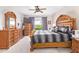 Spacious main bedroom featuring a ceiling fan, wooden furniture and natural light at 25546 N 164Th Dr, Surprise, AZ 85387