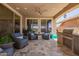 Comfortable outdoor living space with wicker furniture, ceiling fan, and an outdoor kitchen setup at 25546 N 164Th Dr, Surprise, AZ 85387