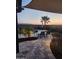 Covered backyard patio with lounge chairs, palm trees, and a view of surrounding mountains at 25546 N 164Th Dr, Surprise, AZ 85387
