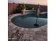 Inviting pool with a waterfall feature, surrounded by lush landscaping and decorative stone at 25546 N 164Th Dr, Surprise, AZ 85387