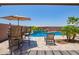 Beautiful pool area with a water feature, surrounded by a patio and lounge chairs for relaxation at 25546 N 164Th Dr, Surprise, AZ 85387