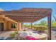 Outdoor patio with pergola, pavers, seating, desert landscaping, and views of community at 26333 W Vista North Dr, Buckeye, AZ 85396