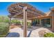Outdoor patio with pergola, pavers, seating, desert landscaping, and views of community at 26333 W Vista North Dr, Buckeye, AZ 85396