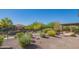 Expansive backyard featuring desert landscaping and a wrought iron fence at 26333 W Vista North Dr, Buckeye, AZ 85396
