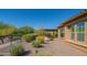 Manicured backyard with desert landscaping, a wrought iron fence, and an outdoor patio at 26333 W Vista North Dr, Buckeye, AZ 85396