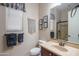 Bathroom featuring granite vanity top, framed art, and decorative macrame wall hanging at 26333 W Vista North Dr, Buckeye, AZ 85396