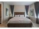 Spacious bedroom featuring neutral walls, carpet flooring, wood bed frame, and soft natural light at 26333 W Vista North Dr, Buckeye, AZ 85396