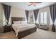 Serene main bedroom with plush bedding, ample natural light, and elegant furnishings create a relaxing retreat at 26333 W Vista North Dr, Buckeye, AZ 85396