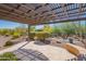 Inviting covered patio with a pergola, seating, and a view of the backyard landscaping at 26333 W Vista North Dr, Buckeye, AZ 85396