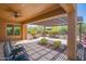 Inviting covered patio featuring outdoor seating, a ceiling fan, and desert landscaping at 26333 W Vista North Dr, Buckeye, AZ 85396