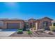 Charming desert home featuring a stone facade, desert landscaping, and a two-car garage at 26333 W Vista North Dr, Buckeye, AZ 85396