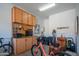 Neat garage with built-in cabinets, workspace, and recreational equipment at 26333 W Vista North Dr, Buckeye, AZ 85396