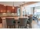 Gourmet kitchen features a large island with seating and dark wood cabinets at 26333 W Vista North Dr, Buckeye, AZ 85396