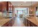 Bright kitchen with granite countertops, tile backsplash, and stainless steel appliances at 26333 W Vista North Dr, Buckeye, AZ 85396