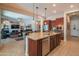 Open kitchen area with an island, sink, seating, and stainless steel appliances at 26333 W Vista North Dr, Buckeye, AZ 85396