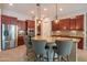 Gourmet kitchen features a large island with seating and dark wood cabinets at 26333 W Vista North Dr, Buckeye, AZ 85396