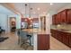 Gourmet kitchen features a large island with seating and dark wood cabinets at 26333 W Vista North Dr, Buckeye, AZ 85396