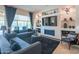 Bright living room with a fireplace, custom built-ins, sleek furniture, and a sliding glass door to outdoor views at 26333 W Vista North Dr, Buckeye, AZ 85396