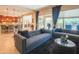 Open living space with a stylish sofa, flowing into a well-equipped kitchen, perfect for modern living at 26333 W Vista North Dr, Buckeye, AZ 85396