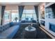 Cozy living room with natural light, a modern fireplace, custom shelving, and comfortable seating arrangement at 26333 W Vista North Dr, Buckeye, AZ 85396