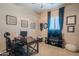Bright home office showcasing a ceiling fan and an ergonomically designed desk and chair at 26333 W Vista North Dr, Buckeye, AZ 85396