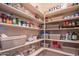 Organized walk-in pantry with abundant shelving for dry goods, food storage, and small appliances at 26333 W Vista North Dr, Buckeye, AZ 85396