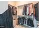 Organized walk-in closet with shelving and hanging rods to maximize storage for clothes and personal items at 26333 W Vista North Dr, Buckeye, AZ 85396