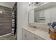 This bathroom features marble-look shower tile, and vanity at 2853 W Ohio St, Apache Junction, AZ 85120