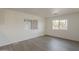Bright bedroom features wood-look flooring and dual windows for natural light at 2853 W Ohio St, Apache Junction, AZ 85120