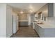 Spacious kitchen with a full-sized refrigerator, modern appliances, and sleek gray cabinetry at 2853 W Ohio St, Apache Junction, AZ 85120