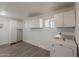 Bright laundry room with plenty of storage cabinets, washer, and dryer at 2853 W Ohio St, Apache Junction, AZ 85120