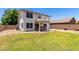 A home's backyard features a lawn, patio, stucco home exterior and wood fence at 2963 S 83Rd St, Mesa, AZ 85212