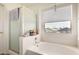 Bright bathroom featuring a shower-tub combo, window, and neutral finishes at 2963 S 83Rd St, Mesa, AZ 85212