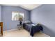 Blue bedroom with a twin bed, neutral carpet, and window at 2963 S 83Rd St, Mesa, AZ 85212
