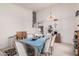This is a dining room with a bright light fixture, stairs in the background, and seating for eight at 2963 S 83Rd St, Mesa, AZ 85212