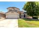 Charming two-story home featuring a well-maintained front yard and attached two-car garage on a sunny day at 2963 S 83Rd St, Mesa, AZ 85212