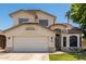 Charming two-story home featuring a well-maintained front yard and attached two-car garage on a sunny day at 2963 S 83Rd St, Mesa, AZ 85212
