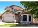 Charming two-story home featuring a well-maintained front yard and attached two-car garage on a sunny day at 2963 S 83Rd St, Mesa, AZ 85212