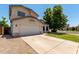 Charming two-story home featuring a well-maintained front yard and attached two-car garage on a sunny day at 2963 S 83Rd St, Mesa, AZ 85212