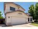 Charming two-story home featuring a well-maintained front yard and attached two-car garage on a sunny day at 2963 S 83Rd St, Mesa, AZ 85212