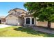 Charming two-story home featuring a well-maintained front yard and attached two-car garage on a sunny day at 2963 S 83Rd St, Mesa, AZ 85212