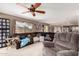 This living room has neutral tones and features a ceiling fan and dark brown couches at 2963 S 83Rd St, Mesa, AZ 85212