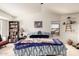 This bedroom features a ceiling fan, large windows, shelving, and a king size bed at 2963 S 83Rd St, Mesa, AZ 85212