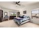 This is a bedroom with large windows, a ceiling fan, and a king sized bed at 2963 S 83Rd St, Mesa, AZ 85212