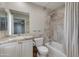 Bathroom featuring tiled walls, granite countertop, and shower-tub combo at 312 S Hardy Dr # 106, Tempe, AZ 85281