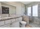 Bathroom featuring granite vanity, toilet and walk-in shower with glass door at 312 S Hardy Dr # 106, Tempe, AZ 85281