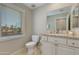 Bathroom with granite vanity, a toilet, tile floor and large window with blinds at 312 S Hardy Dr # 106, Tempe, AZ 85281